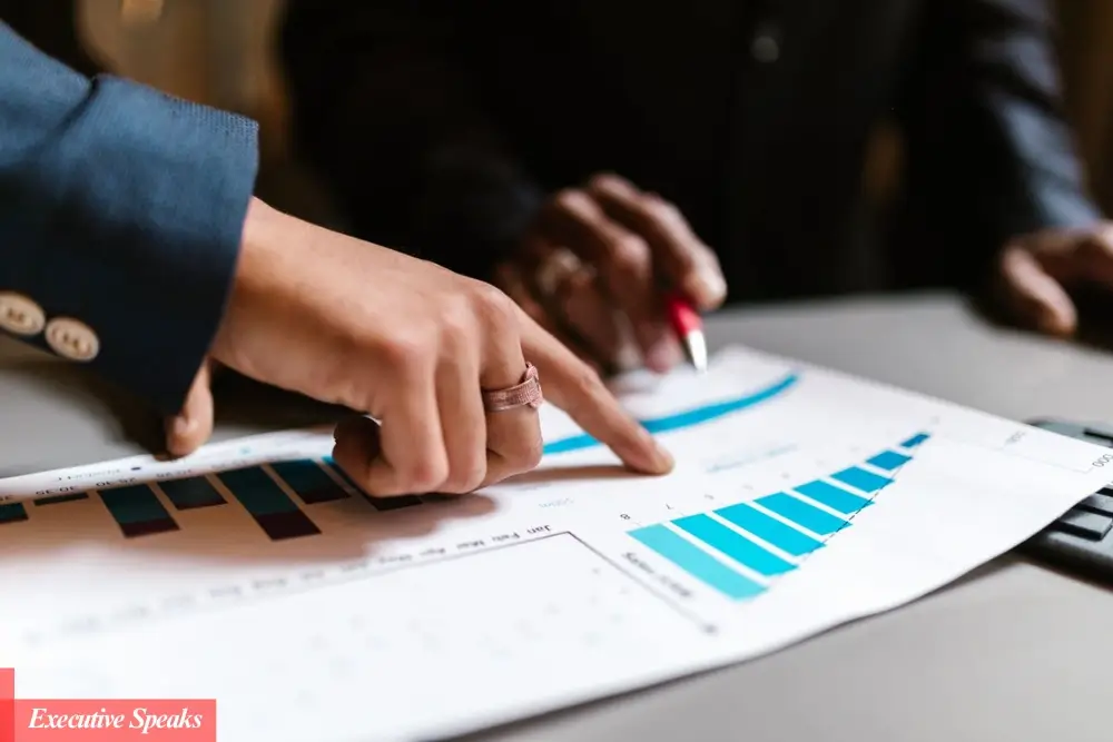 Business professionals analyzing data charts and growth strategy plans on a digital dashboard