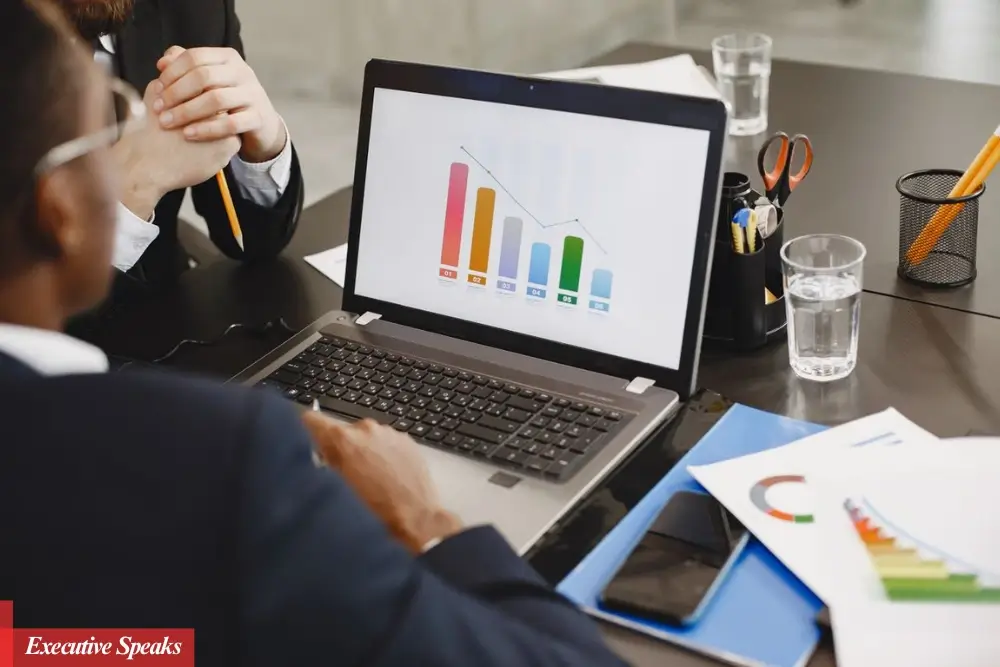 Business professionals reviewing sustainable growth strategy charts and financial performance metrics in a modern office setting