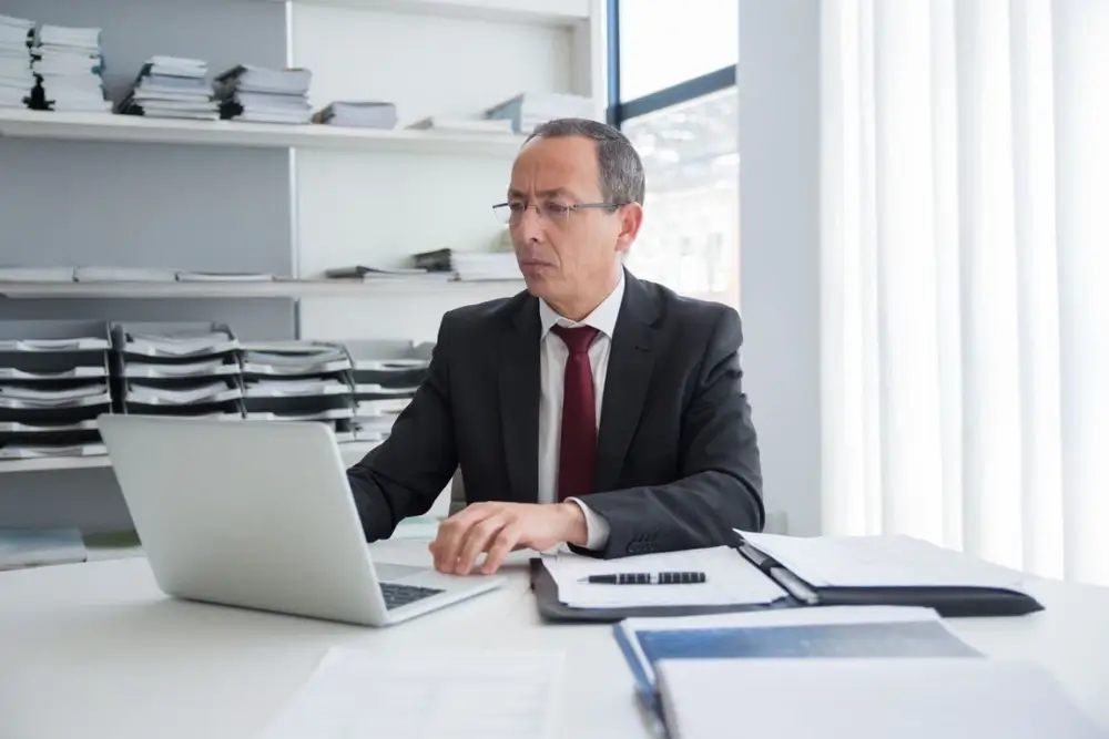 Small business owner reviewing a privacy policy document on a laptop