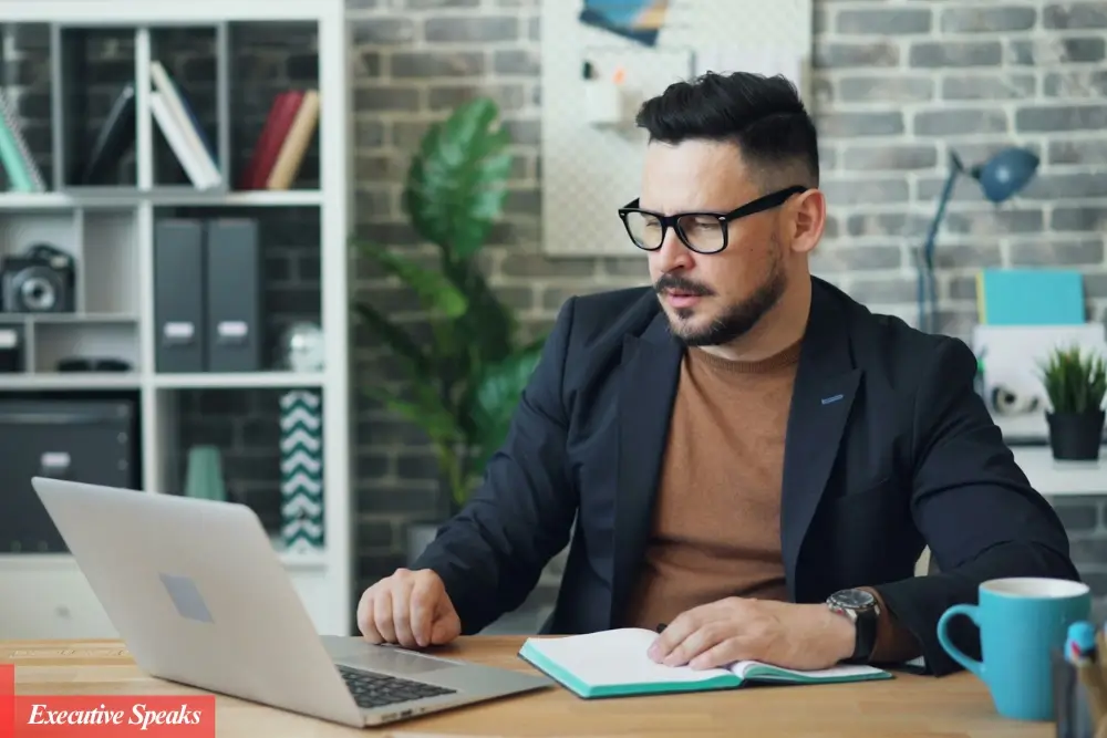 Successful CEO reviewing weekly planner and structuring priorities at a modern office desk