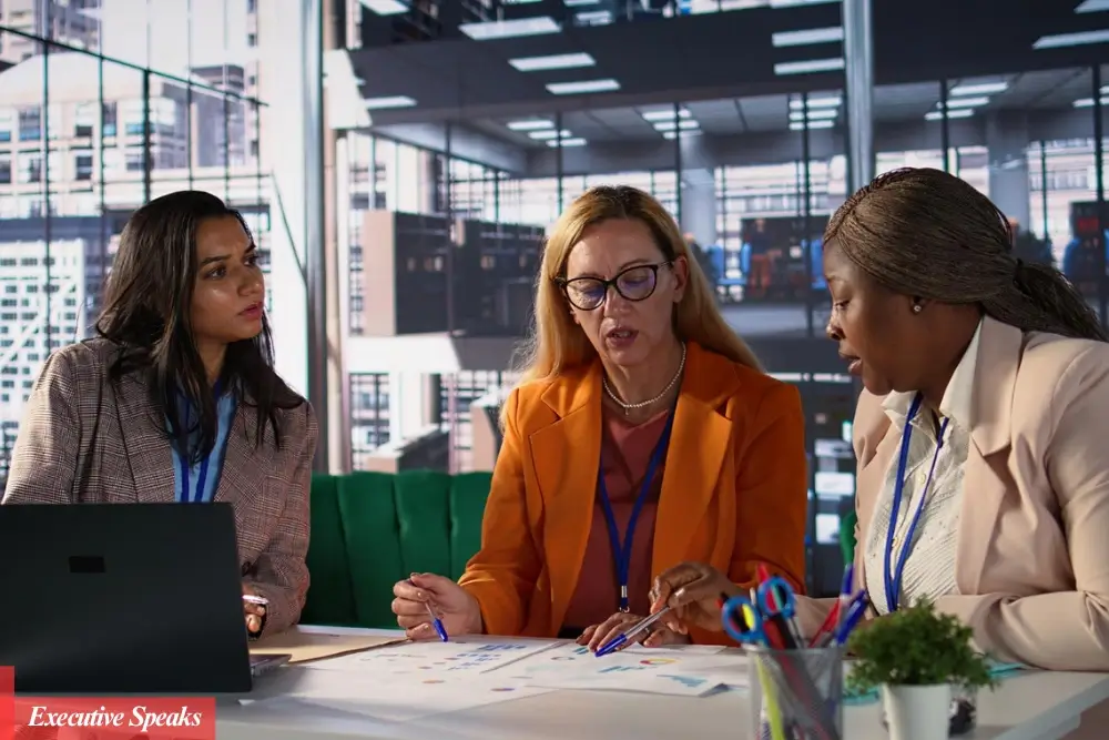 Women entrepreneur discussing funding strategies with investors at a 2025 startup conference