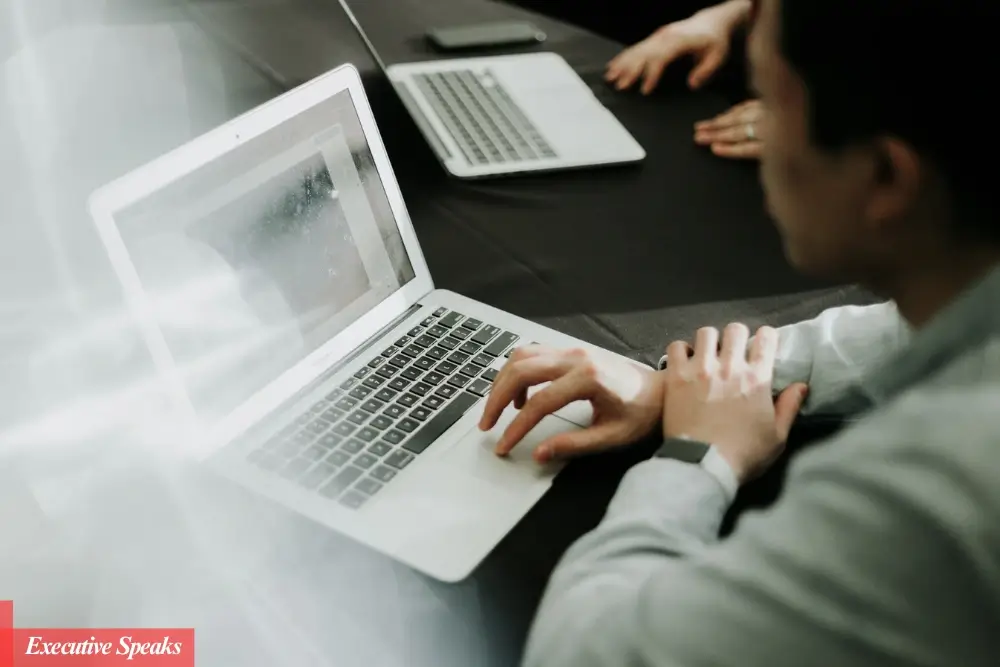 Small business owner using AI tools on a laptop to streamline operations and marketing tasks