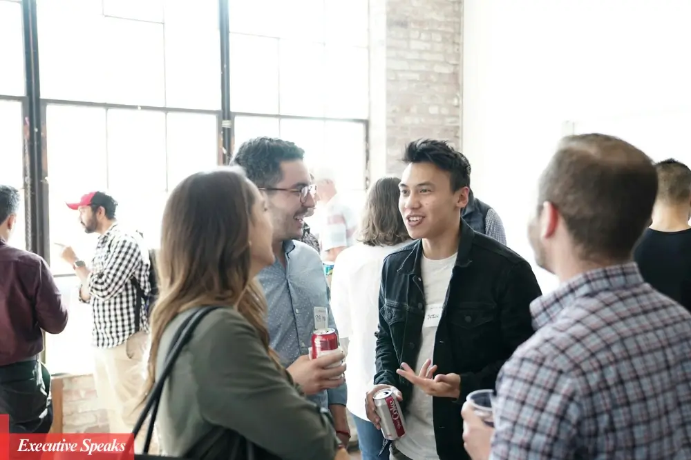 Professional business people networking and shaking hands at a corporate event