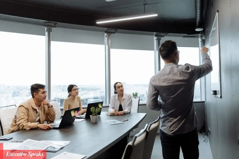 CEO demonstrating emotional intelligence while leading a team meeting in a modern office