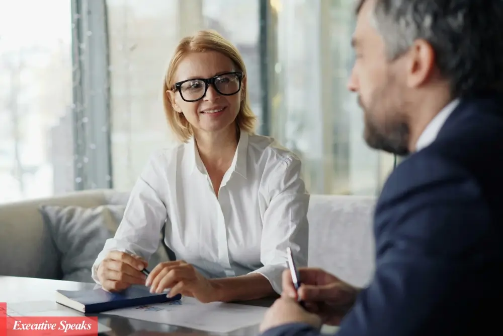 Manager having a difficult one-on-one conversation with an employee in a professional office setting