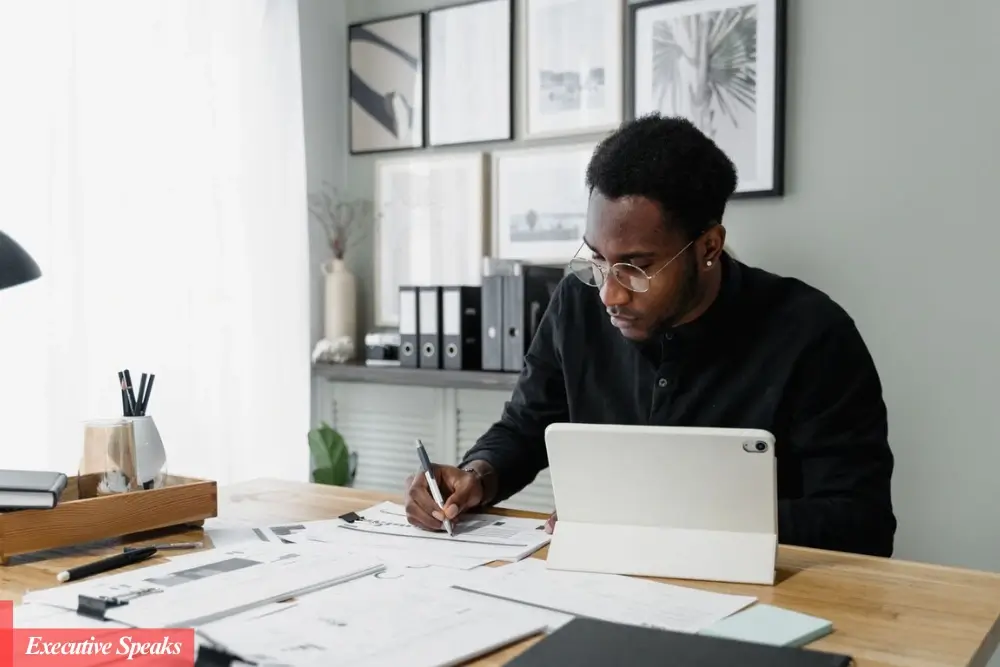 Millennial working on a digital planner template on a tablet for a side hustle business
