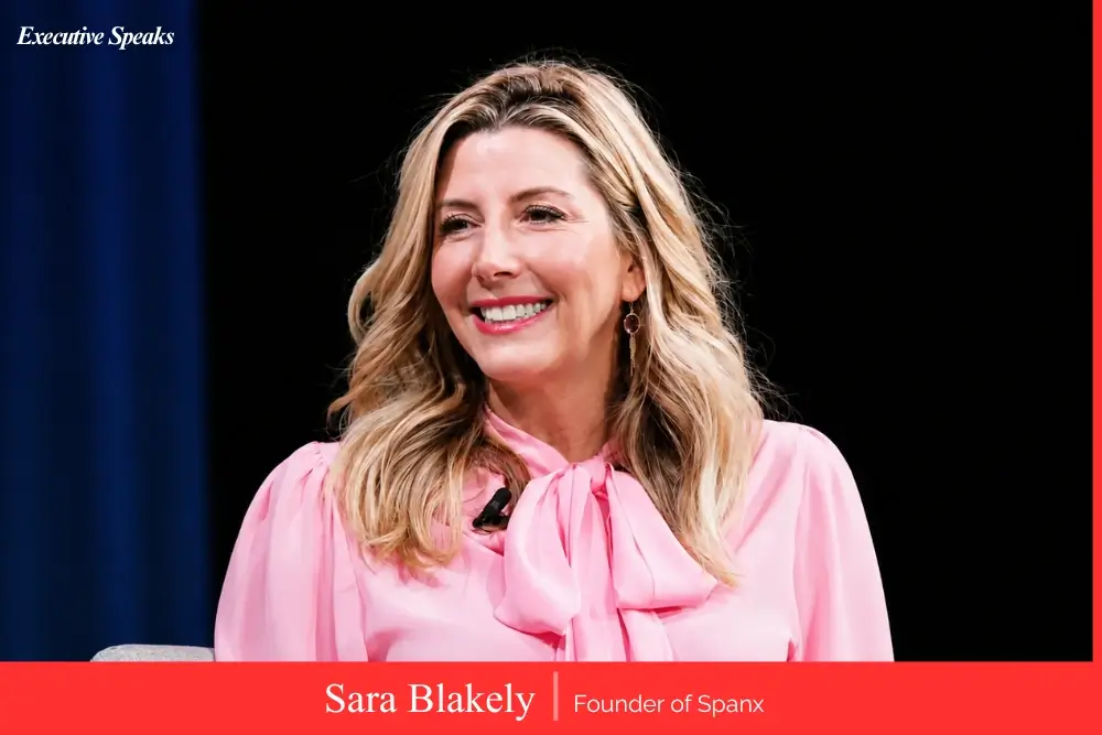 Sara Blakely founder of Spanx holding product representing her bootstrap startup journey